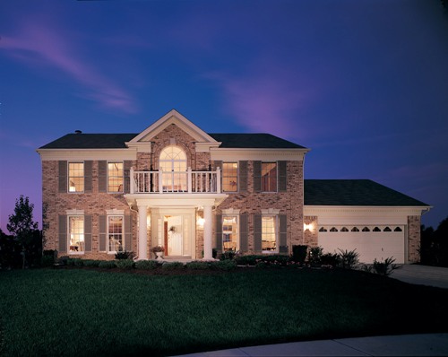 The front of a Traditional house plan at night