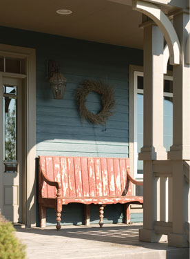 distressed bench adds charm to this covered porch