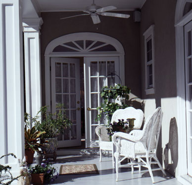 covered porch with white wicker furniture