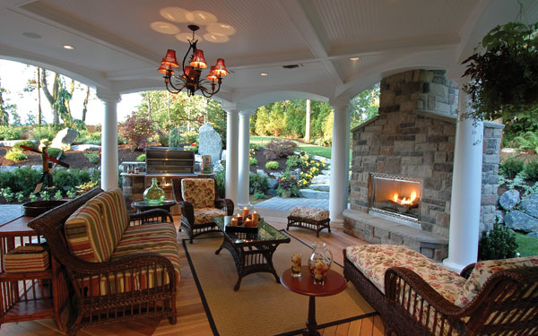stunning covered outdoor living area with fireplace