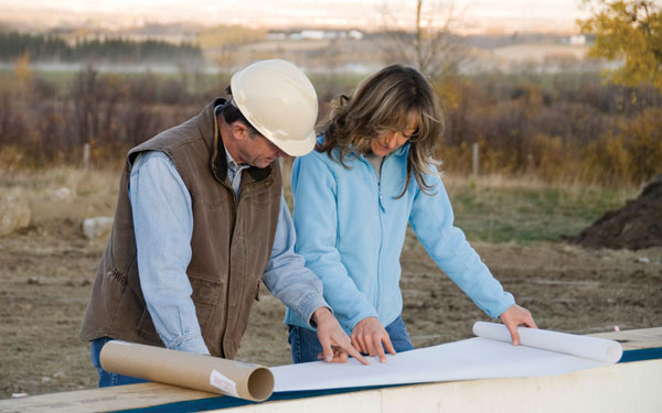 woman and contractor discussing changes to a house plan design