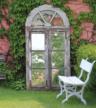 country style garden with decorative mirror enlarges space