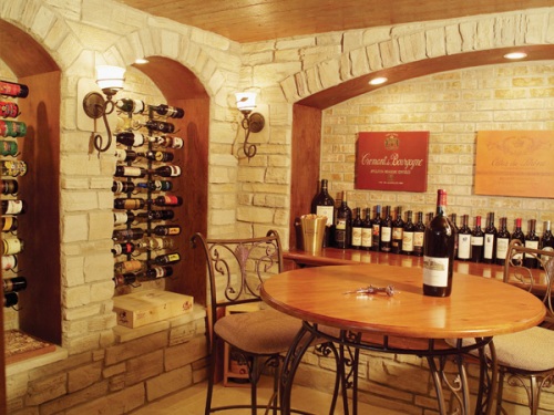 luxury wine cellar with stone walls and seating