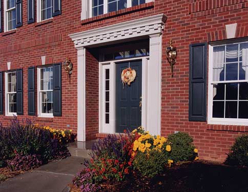 beautiful colonial home entry with fall landscaping