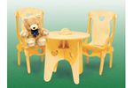 This doll's table and chairs includes a table with heart cut-outs and two chairs of the same design