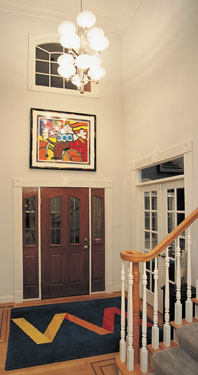 Contemporary entry foyer with modern chandelier