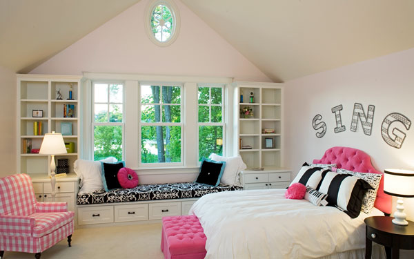 bookcases flanking a window in a bedroom