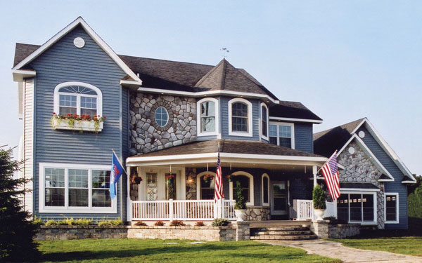 Victorian house plan with American flags in front Victorian house plan with American flags in front