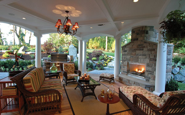 cozy covered patio with outdoor fireplace