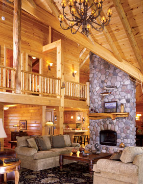 large log home living area with stone fireplace