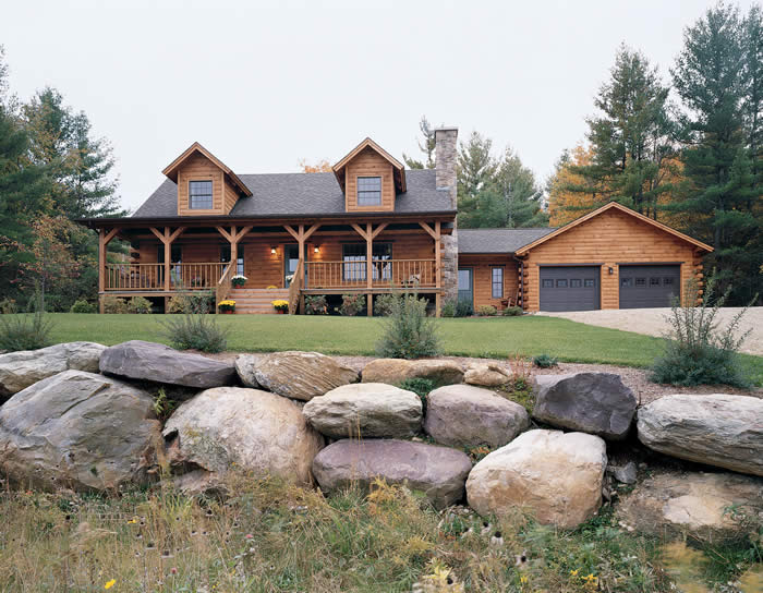 log cabin home with rock landscaping