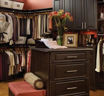 dark wood cabinetry in this luxury master bedroom walk-in closet