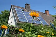 cottage style home with solar panel on the roof