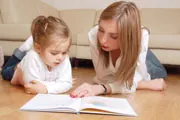 mother and daughter sitting on floor