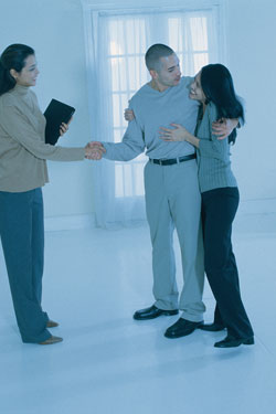 couple shaking hands with banker